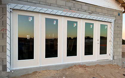 Four ceiling to floor windows with matching door installed in a double garage.